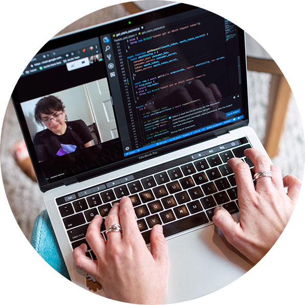 woman using laptop with video conference and coding on screen