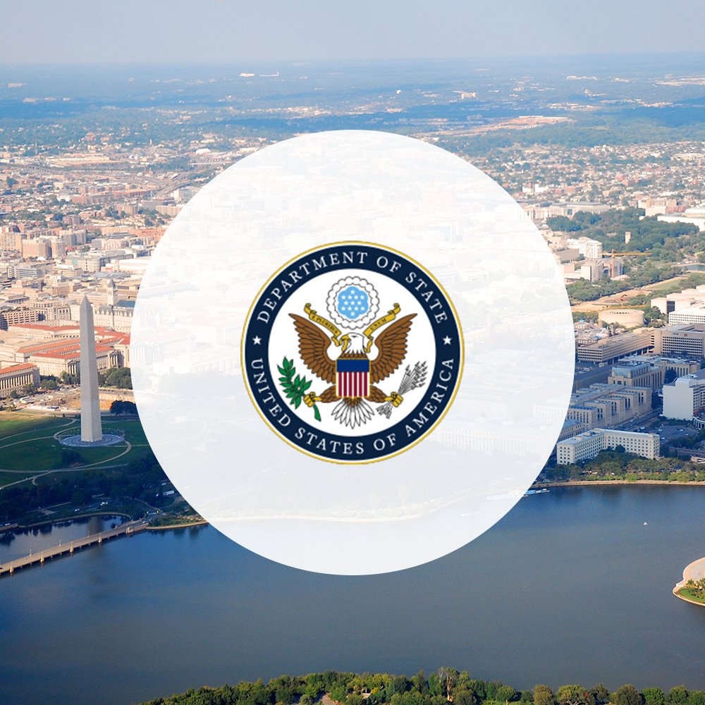 U.S. Department of State logo on top of Washington, D.C. aerial view